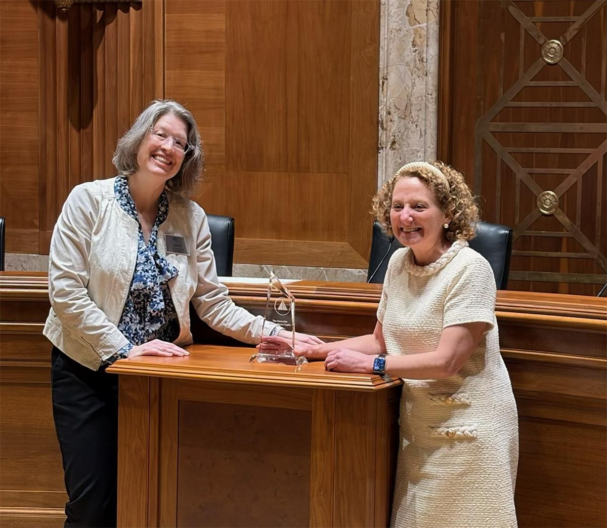 PAA VP Sarah Burgard presents the Excellence in Public Service Award to Senator Capito's advisor Dana Richter